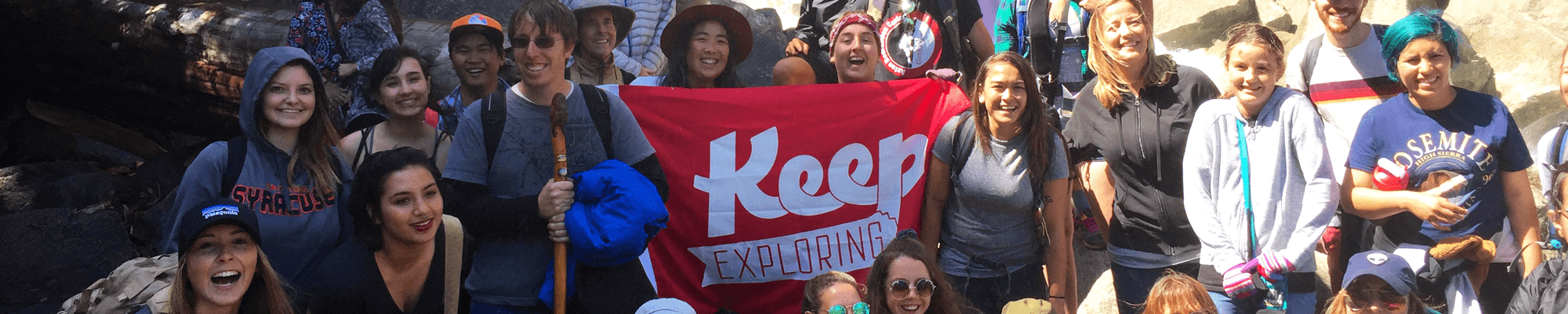 Geography field trip to Yosemite, group photo, banner being held that says Keep Exploring